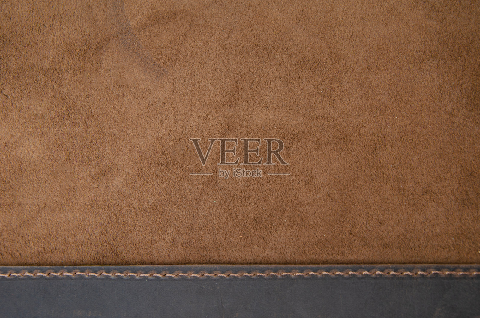 棕色天然皮革的质地。仿麂皮纹理。照片摄影图片
