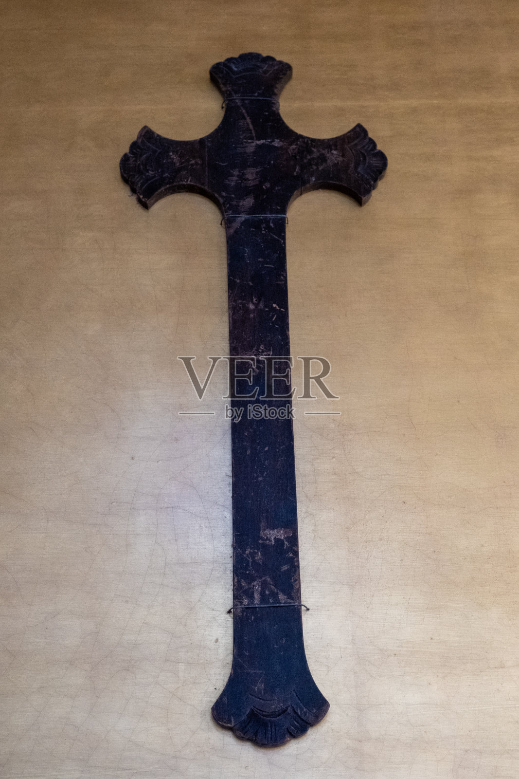 为庆祝圣周,铁十字架暴露在布尔戈斯大教堂的金色墙壁上。照片摄影图片