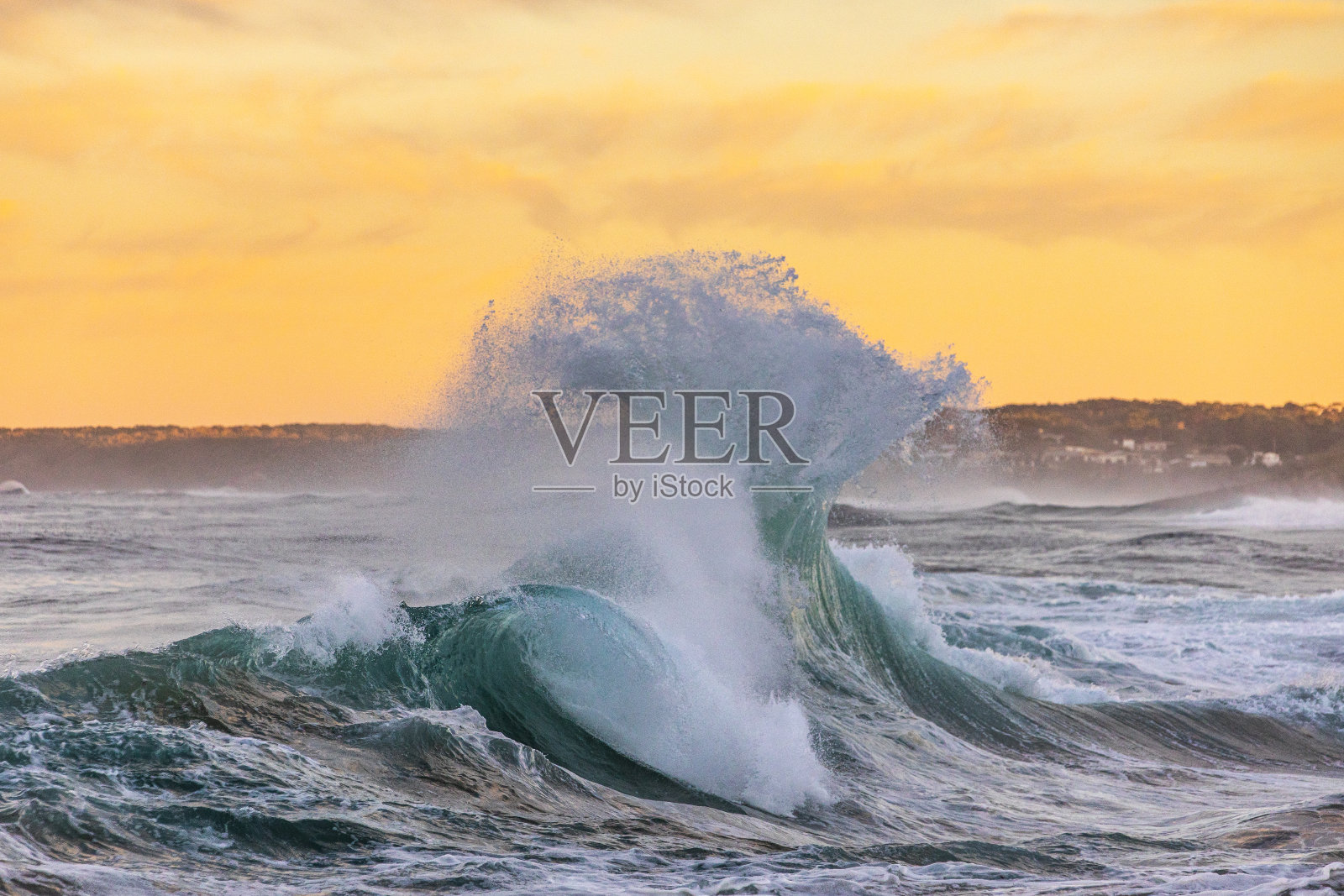 强有力的展示海浪碰撞在戏剧性的光线下产生水爆炸照片摄影图片