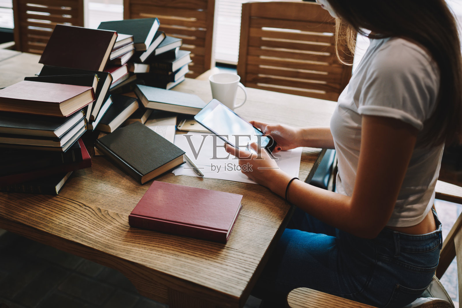 学生一边做作业一边浏览平板电脑照片摄影图片