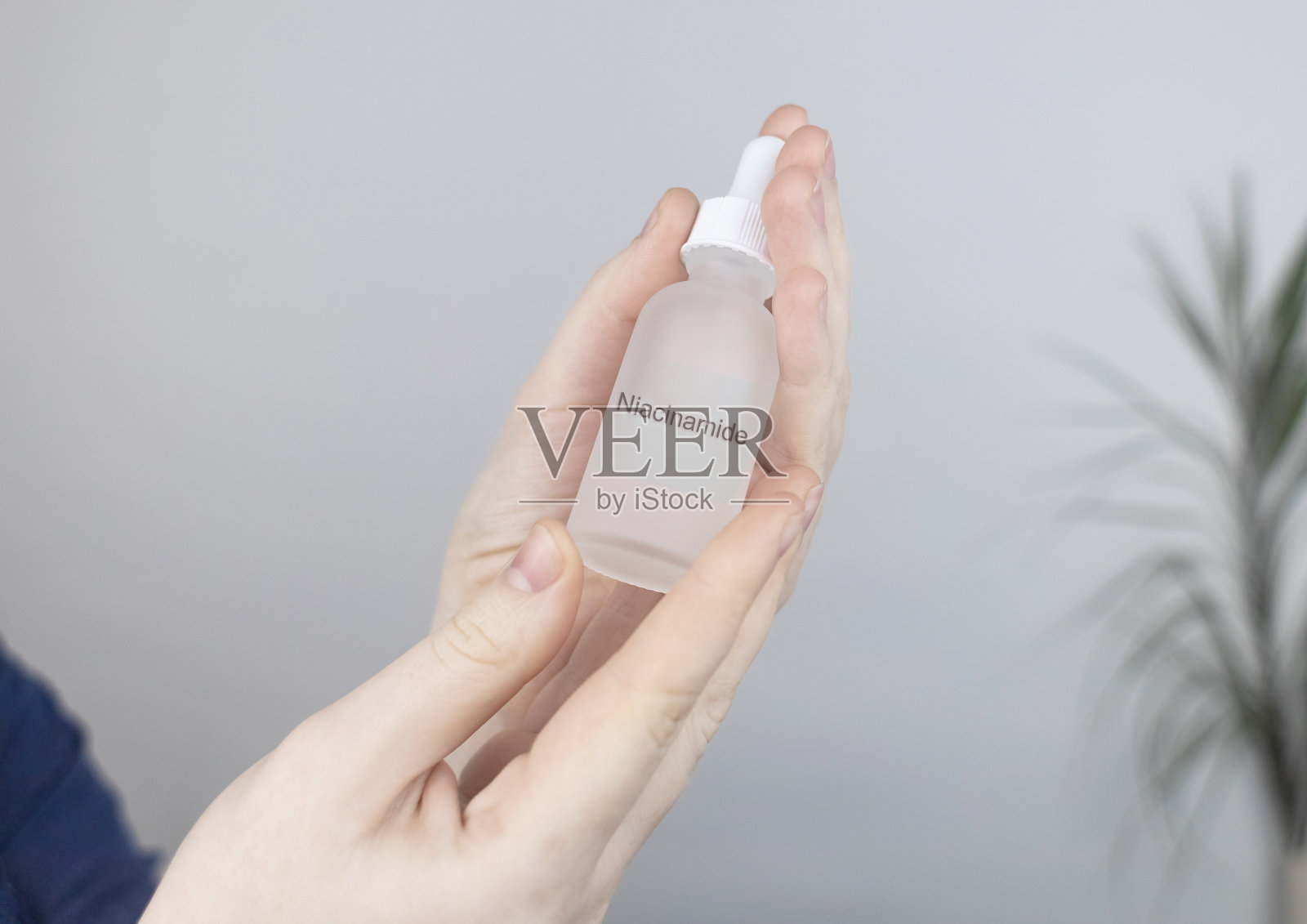 烟酰胺。女孩在脸上涂抹维生素b3。实验室研究。护肤品。皮肤血清。乳状液用于缩小毛孔,正常化皮脂生产和减轻色素沉着照片摄影图片