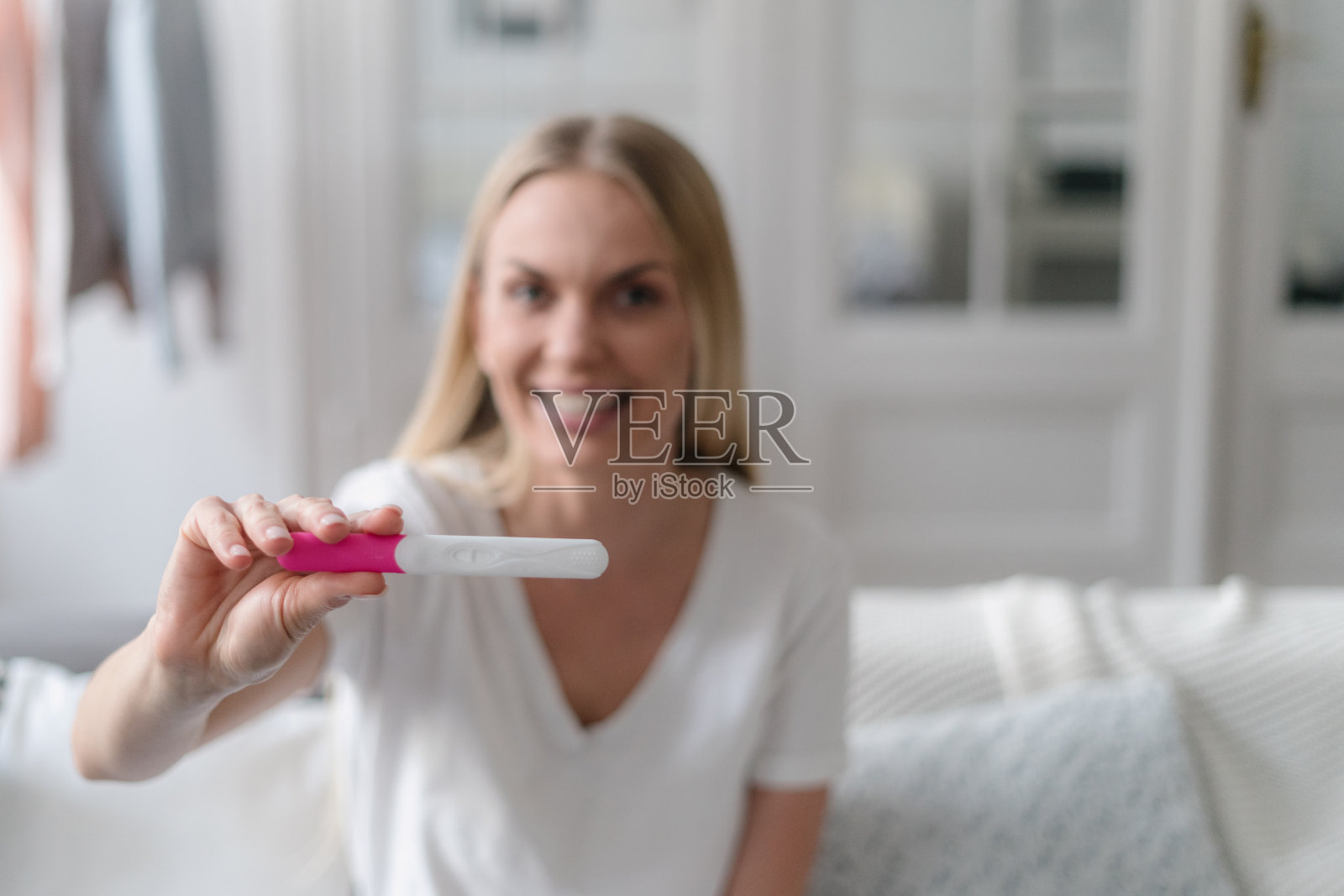 快乐的女人手里拿着验孕棒照片摄影图片