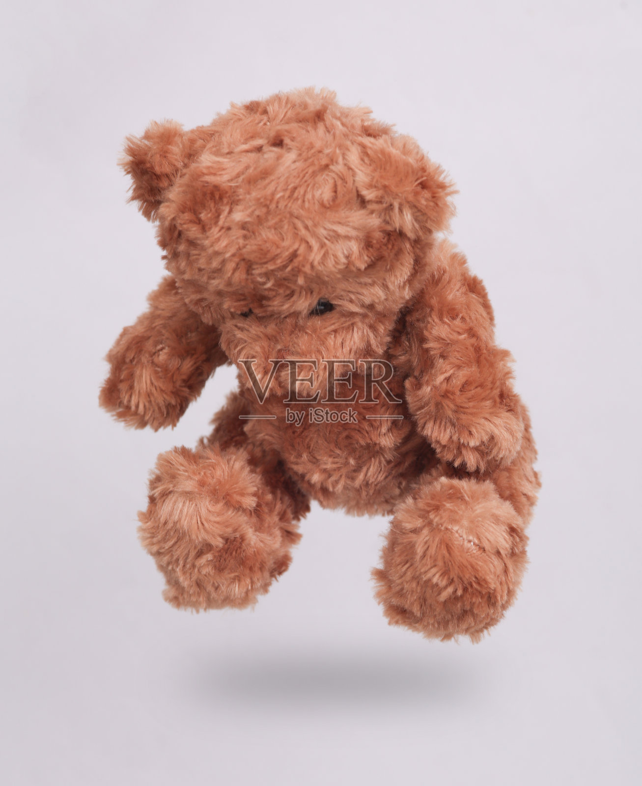 泰迪熊悬浮在白色背景与阴影照片摄影图片