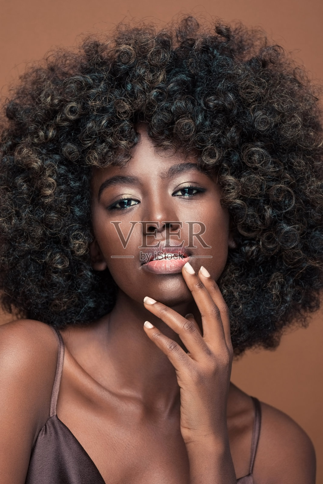 年轻女子的肖像与爆炸头的头发照片摄影图片