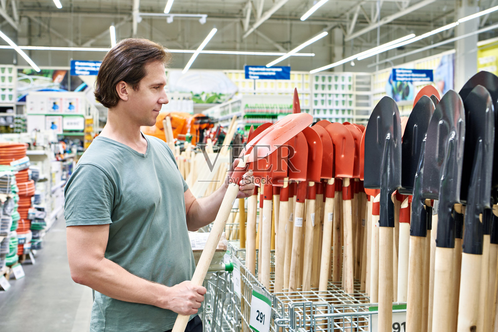 一个人在商店里买了一把铲子照片摄影图片