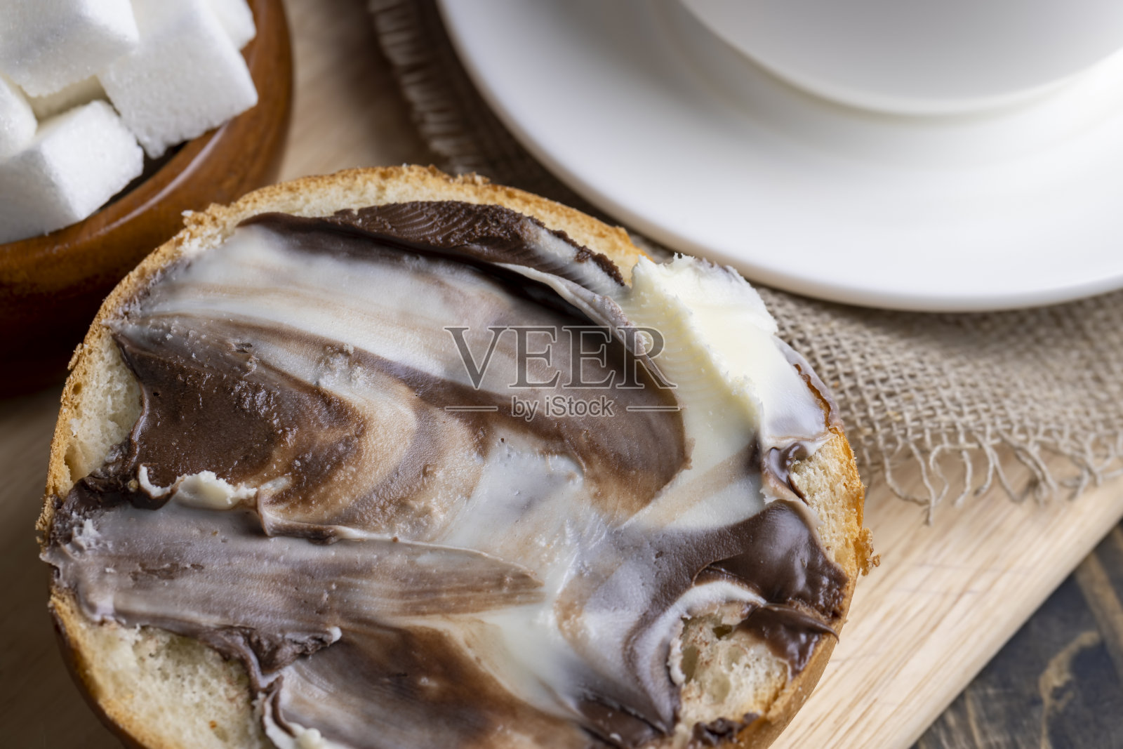 桌上放着涂了巧克力黄油的面包片照片摄影图片