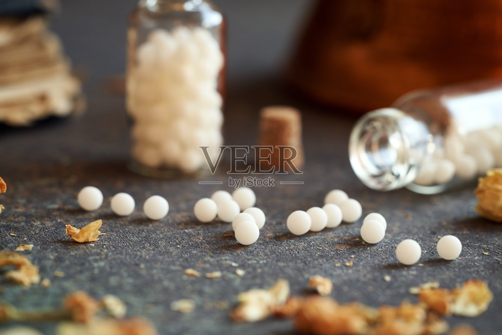 顺势疗法的小球从瓶子里洒出来照片摄影图片