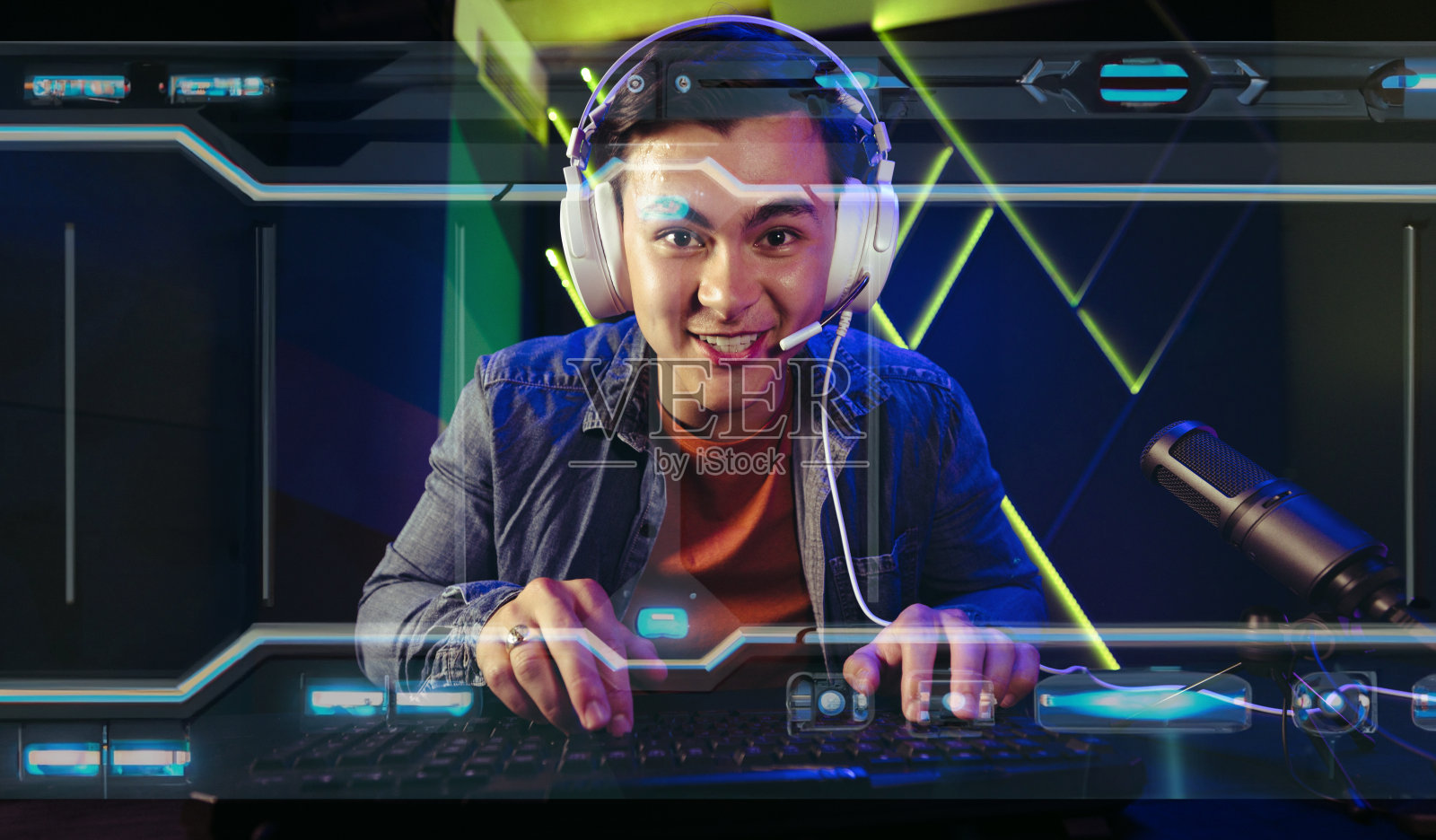 一位男性玩家坐在电脑屏幕前,沉浸在一款令人兴奋的第一人称射击视频游戏中照片摄影图片