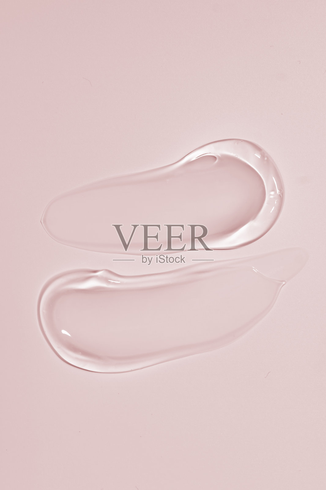 挤压的化妆品透明乳霜凝胶纹理被隔离在米色背景上。近距离透明血清滴涂片照片摄影图片