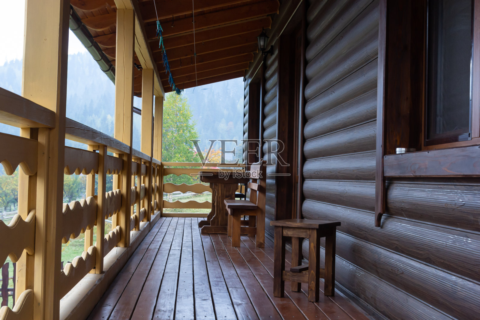 美丽的现代露台休息室,一个大的木制露台在一个木屋周围的森林。自然与度假概念照片摄影图片