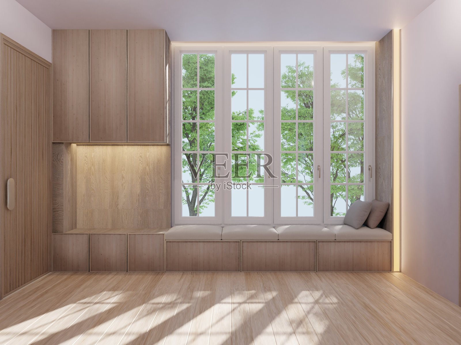 一间极简风格的空客厅,带有嵌入式橱柜和靠窗的休息区。照片摄影图片