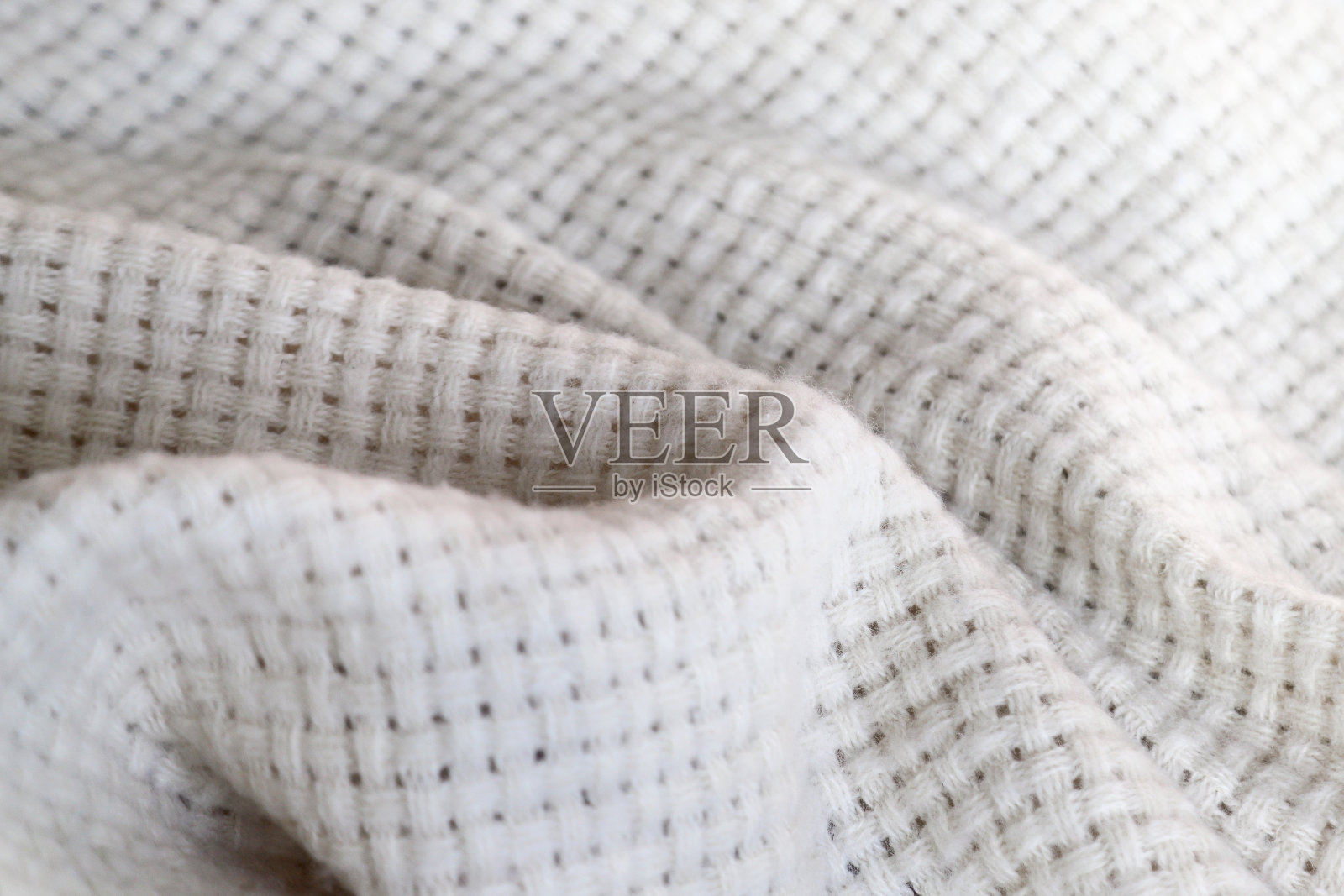 波浪形表面以温暖舒适的白色织毯为背景照片摄影图片