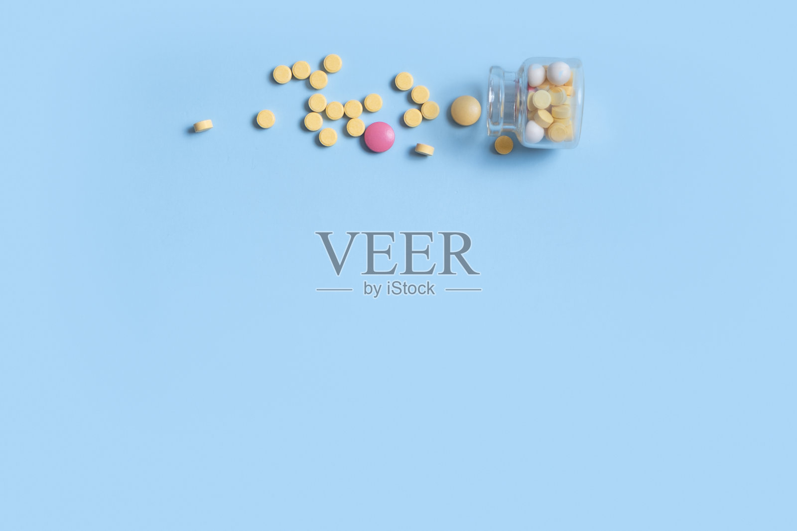 蓝色背景的彩色药丸,带有复制空间。医疗保健和医药背景平平照片摄影图片