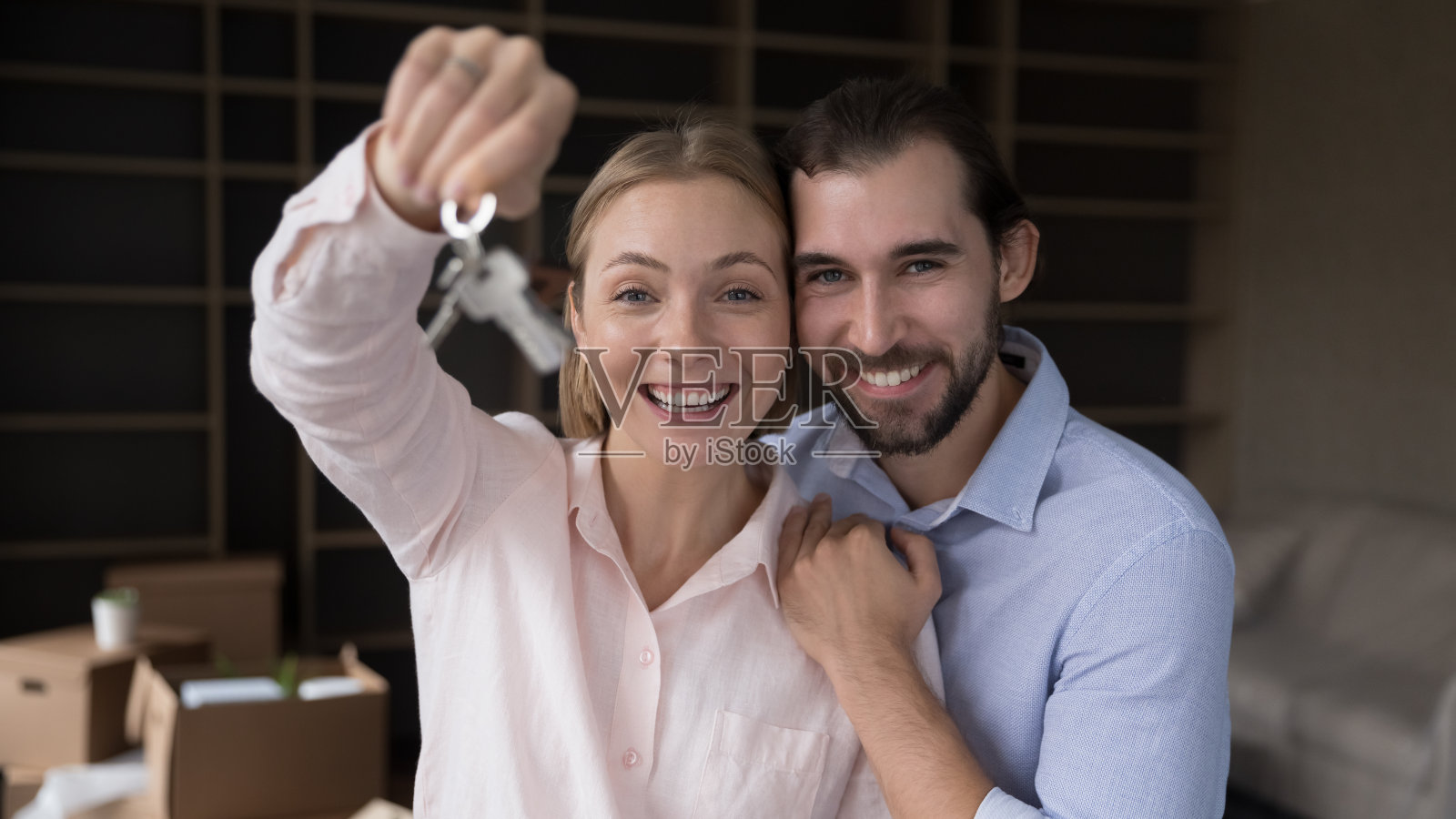 幸福兴奋的夫妇在镜头前展示钥匙照片摄影图片