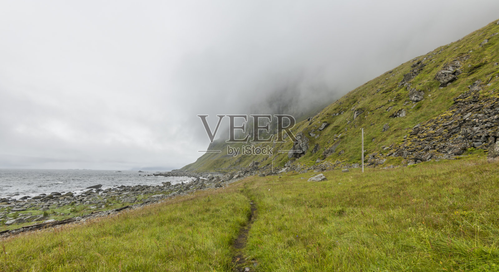 在罗弗敦群岛的veroy岛(Værøy)的岩石海滩上,天空喜怒无常,狂风暴雨。巨石、岩石、挪威、荒野。坏天气。天,夏天。复制空间,负空间照片摄影图片