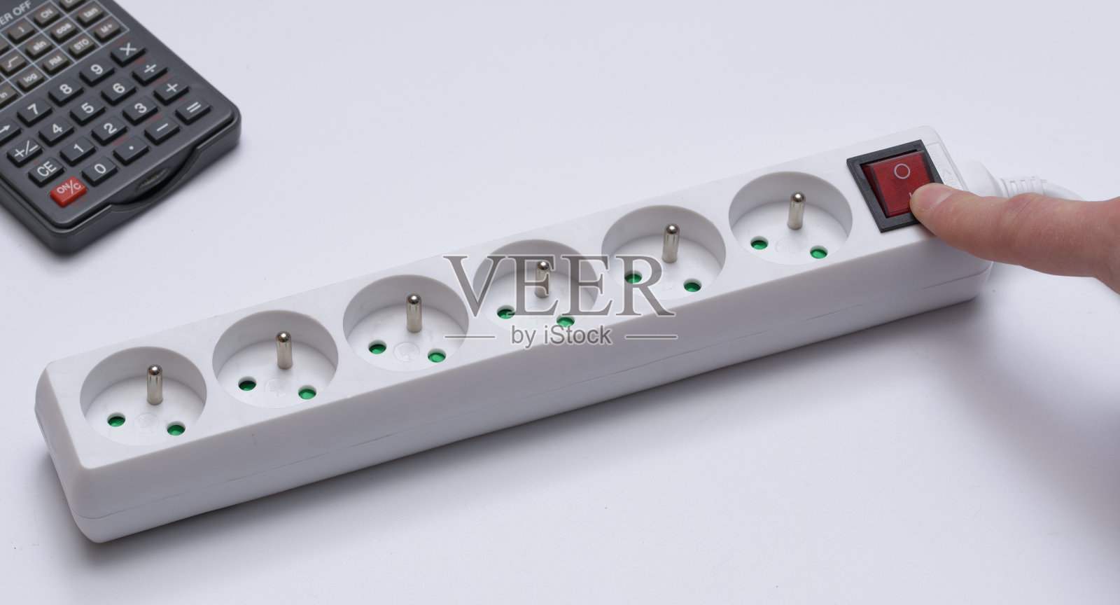 白色背景上的延长线旁边是计算器照片摄影图片