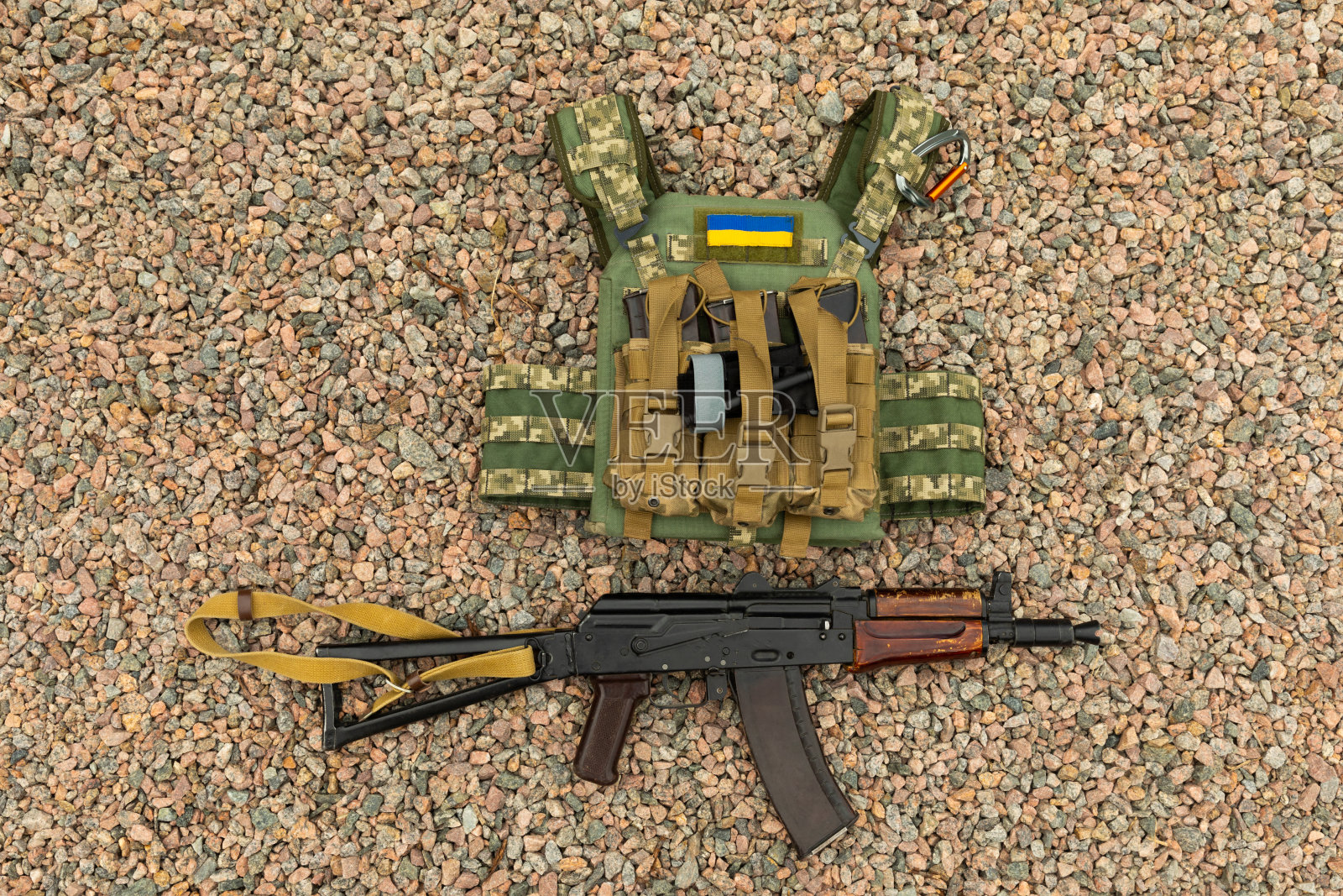 军用防弹衣和一把卡拉什尼科夫突击步枪。带有战斗屁股的防弹衣。乌克兰军队。军事概念。没有战争。照片摄影图片
