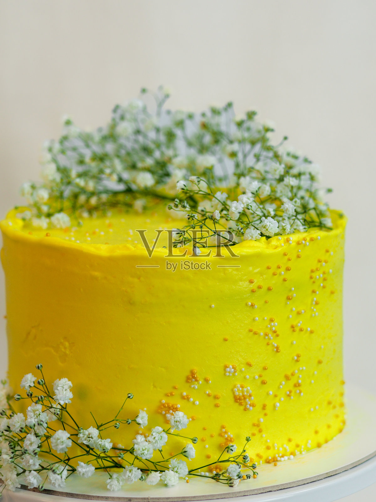 工作室拍摄的黄色花卉庆典磨砂杯蛋糕孤立的白色背景照片摄影图片