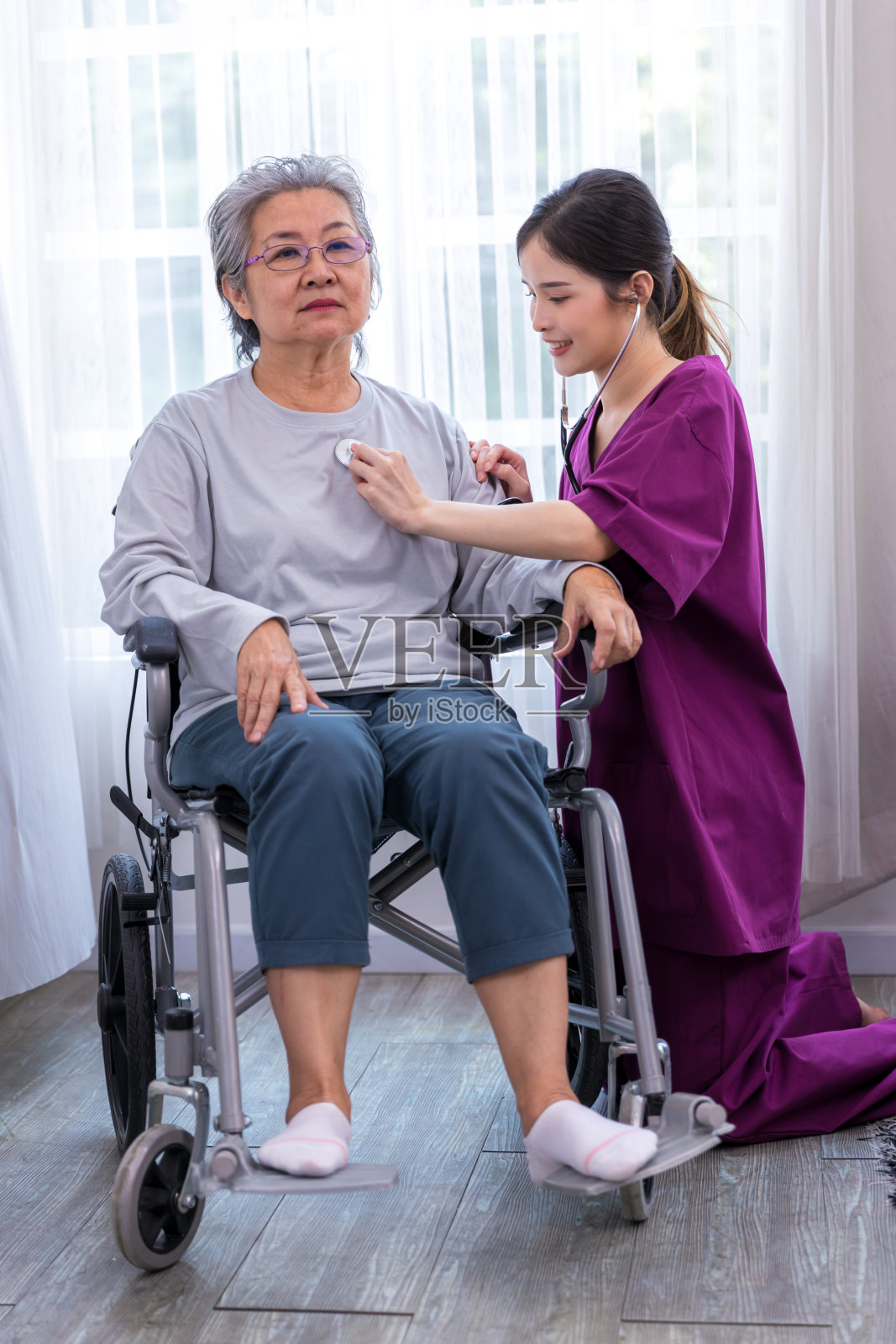 护理员照顾一位在公园散步的老年病人。护士帮助老年妇女照片摄影图片