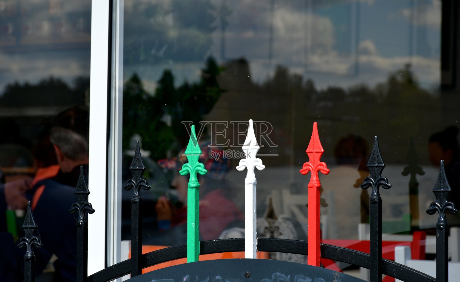 一个餐馆旁边的栅栏上的特写,被漆成绿色、白色和红色,就像在一个阳光明媚的夏日里在波兰乡村徒步旅行时看到的意大利国旗照片摄影图片