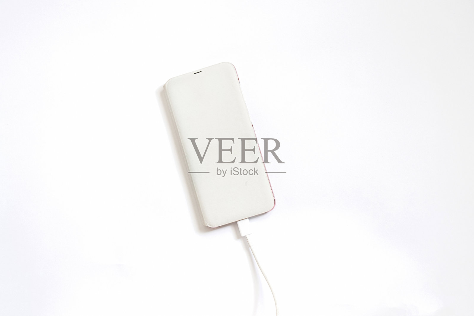 手机装在白色的盒子里,充电器在白色的背景上照片摄影图片