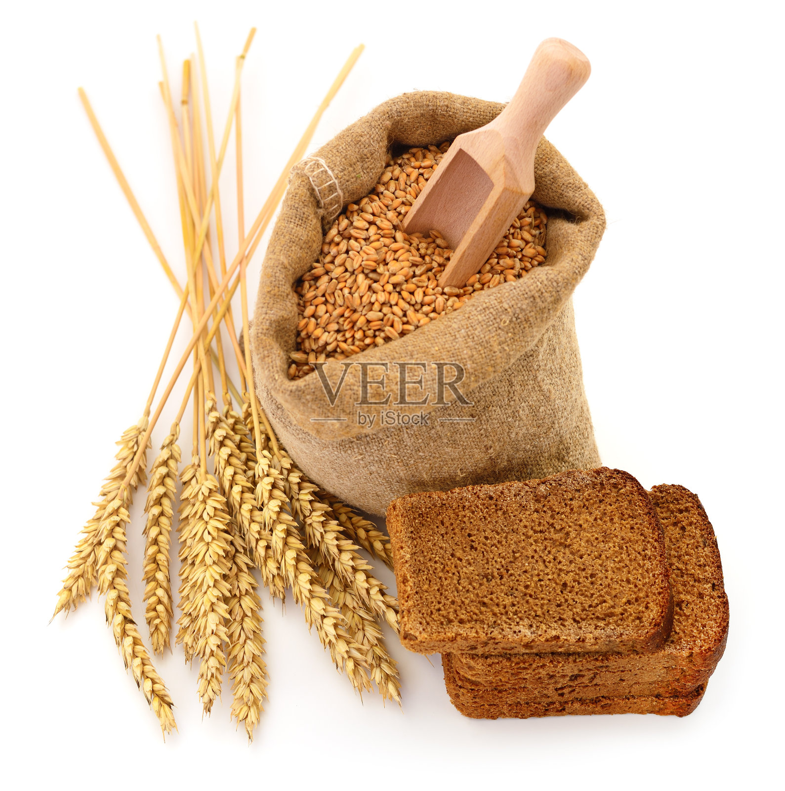麻袋里装着小麦,耳朵和面包。照片摄影图片