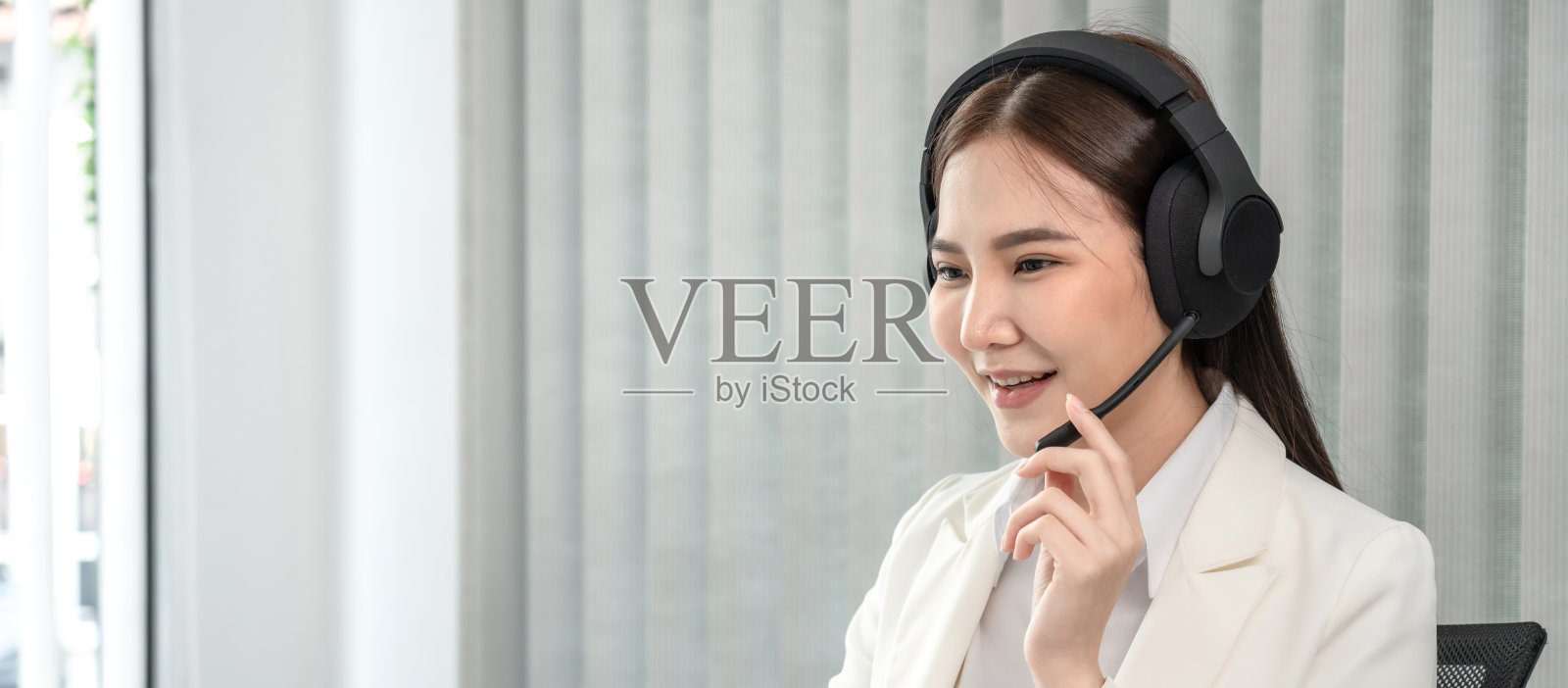 女性呼叫中心为寻求帮助的客户提供信息,联系我们,以优美友好的声音提供服务,长途通信,使用耳机或耳机通话照片摄影图片