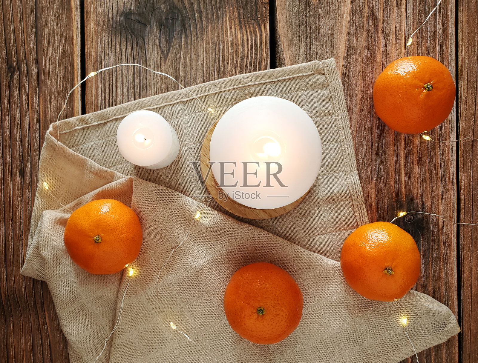 橘子,木头背景上燃烧的蜡烛照片摄影图片