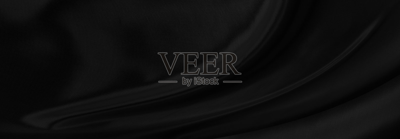 黑灰色缎面深色面料纹理豪华闪亮,是抽象的丝绸布料全景背景与图案柔和的波浪模糊美丽。照片摄影图片