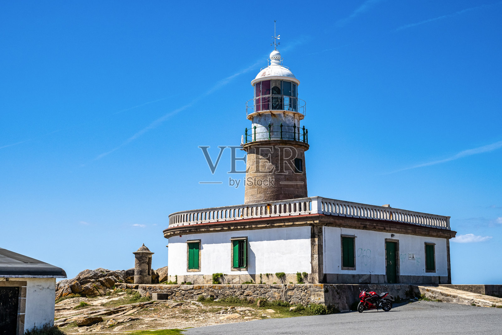 西班牙加利西亚大西洋上的瓦罗贝多灯塔。岩石峭壁上的灯塔照片摄影图片