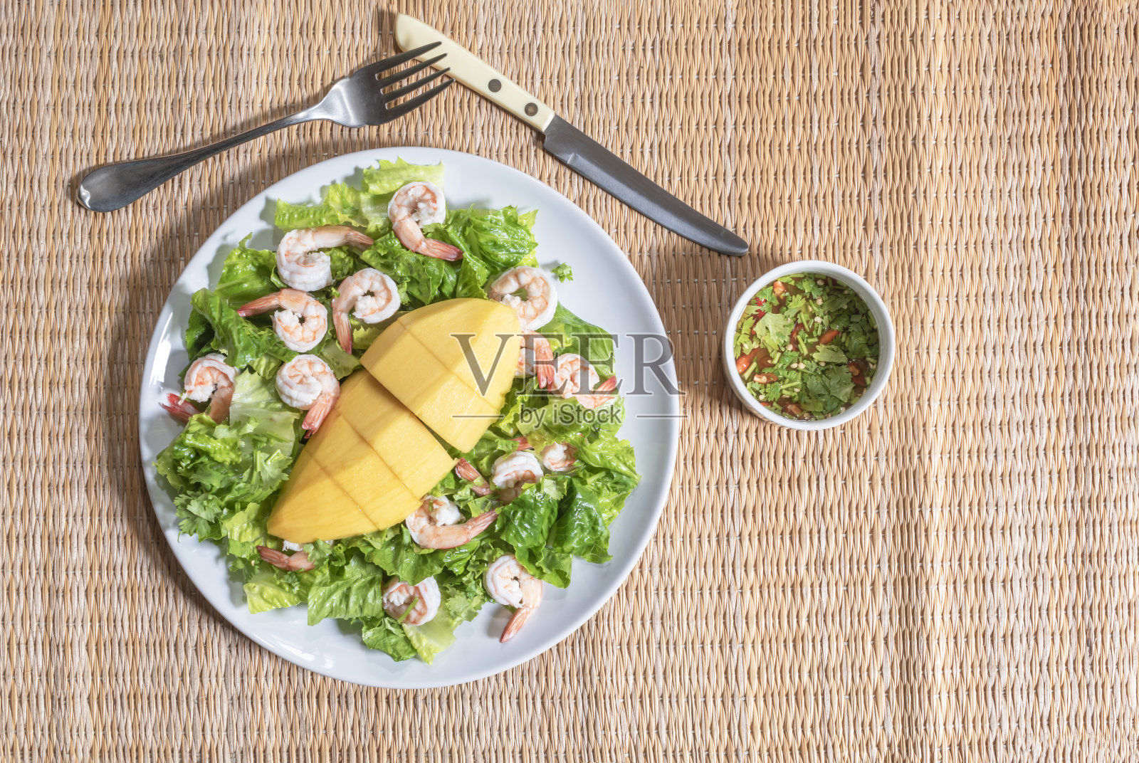 健康食品虾沙拉有芒果长叶莴苣碗有海鲜酱木背景。照片摄影图片