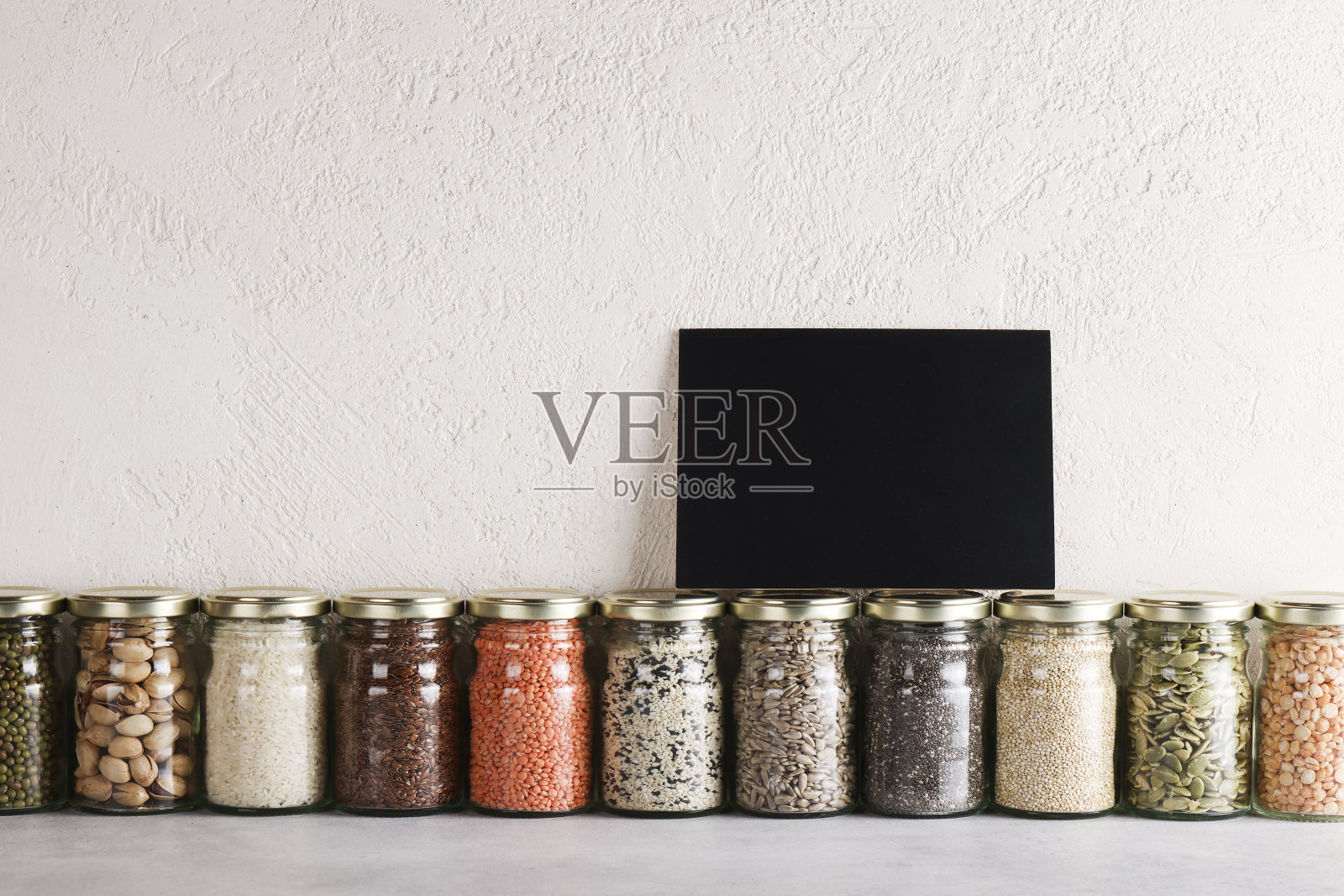 零废物生活理念。负责任消费,健康素食。玻璃上的黑板文字,上面有含有蛋白质和脂肪的食物。照片摄影图片