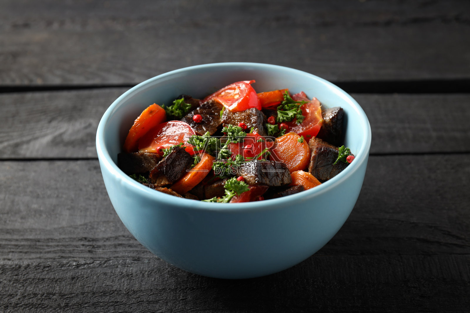 木质背景上的蔬菜牛肉盘照片摄影图片