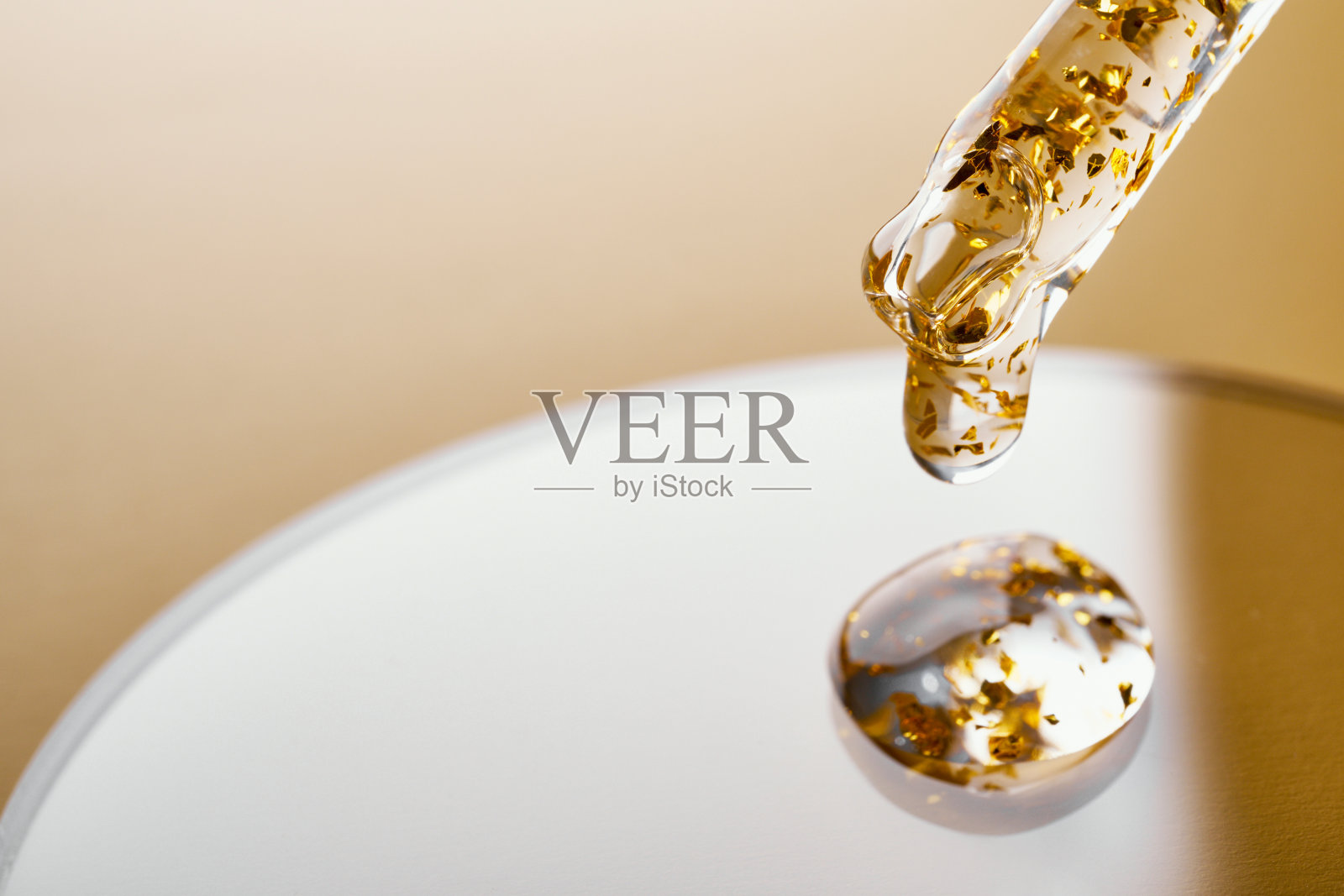 移液器和凝胶化妆品与黄金在米色背景的培养皿照片摄影图片