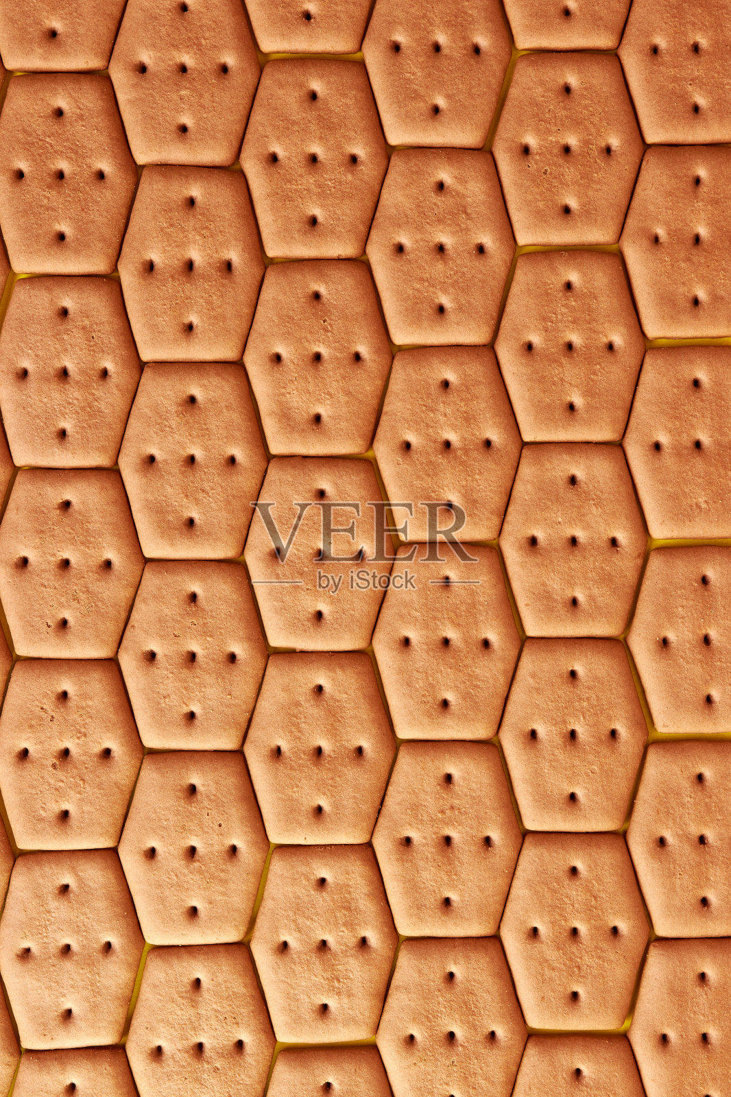 我们用六边形的饼干做背景。美味又甜的小吃。照片摄影图片