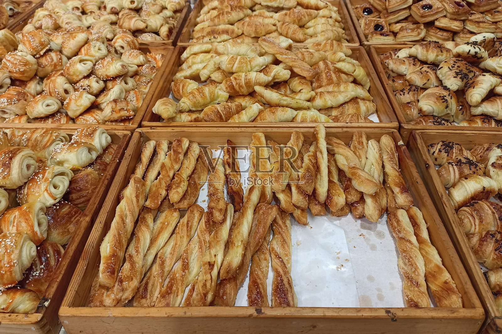 迷你羊角面包在展示商店。新鲜出炉,有巧克力、奶酪、香蕉等多种口味。照片摄影图片