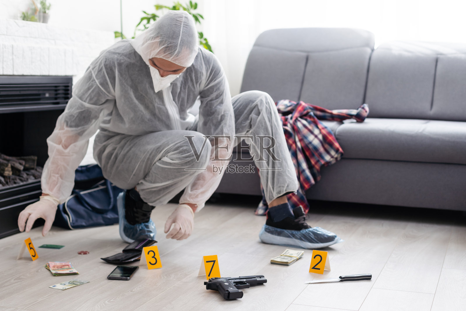 在犯罪现场收集证据的侦探。法医专家在死者家中进行鉴定。由专业警务人员调查凶杀案。照片摄影图片