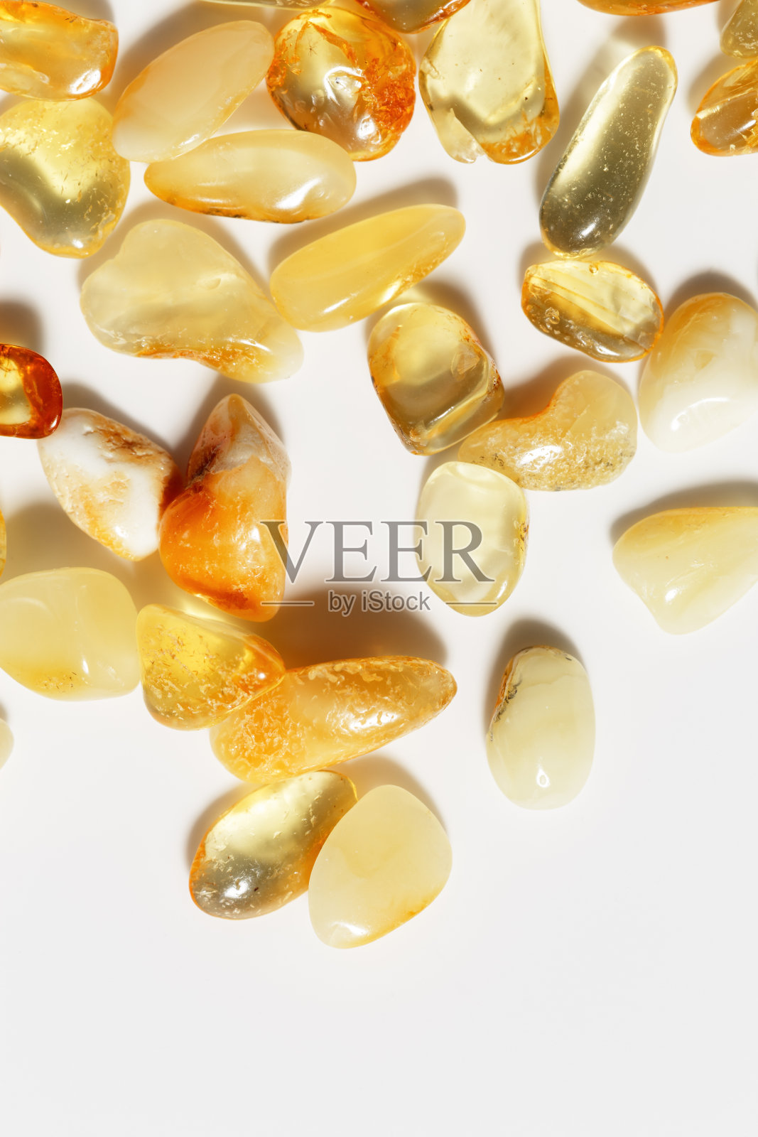 宝石呈琥珀色,底色较浅,透明的石头呈黄米色渐变。天然宝石矿物愈合晶体。俯视图琥珀纹理。天然宝石,古树脂片。照片摄影图片