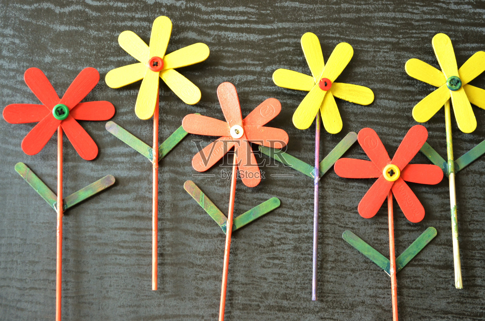 DIY艺术和工艺彩色冰棒棍棒涂上不同的颜色,并制作成美丽的花朵。令人满意的。爱好创意幼儿园照片摄影图片