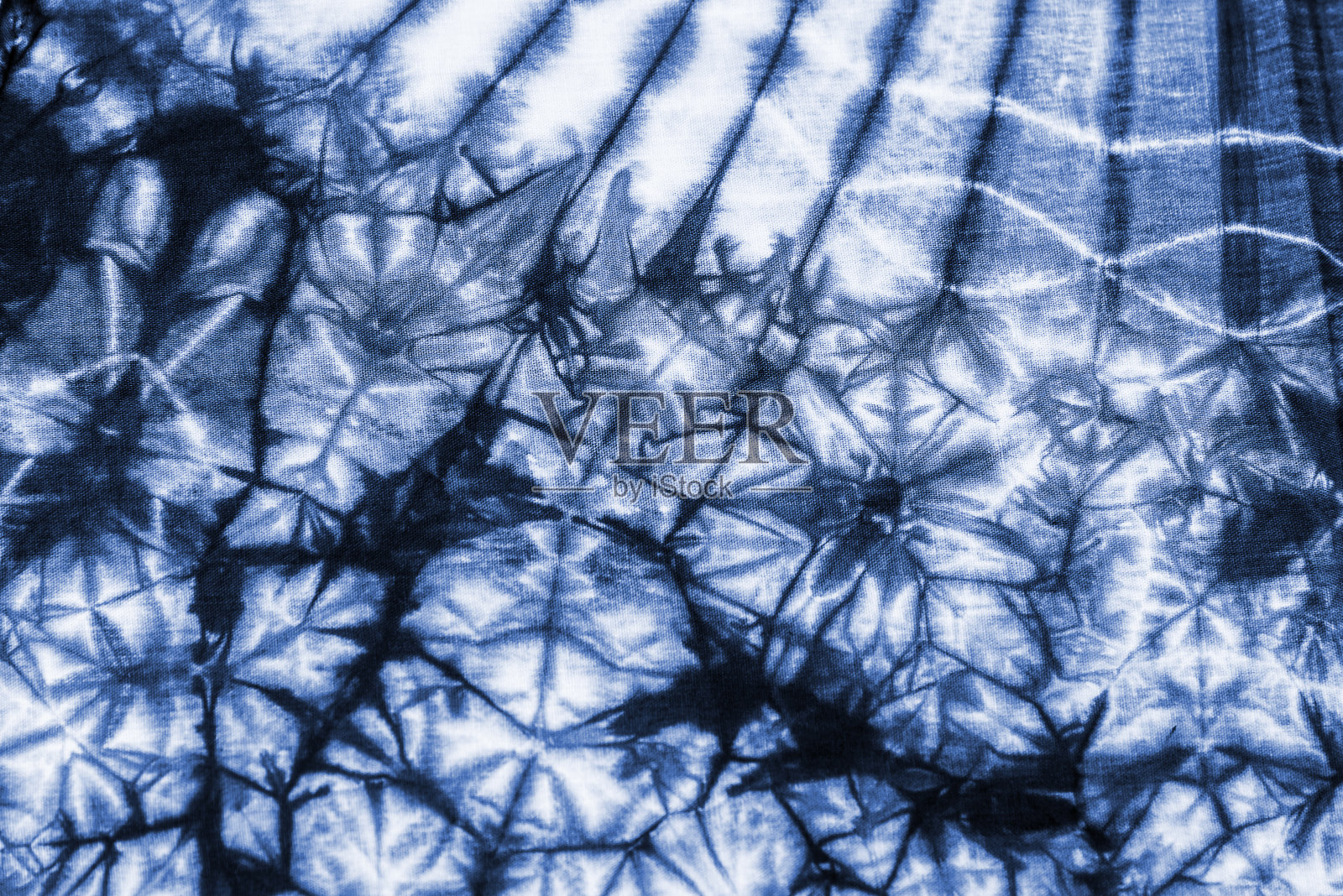 质地扎染织物。照片摄影图片