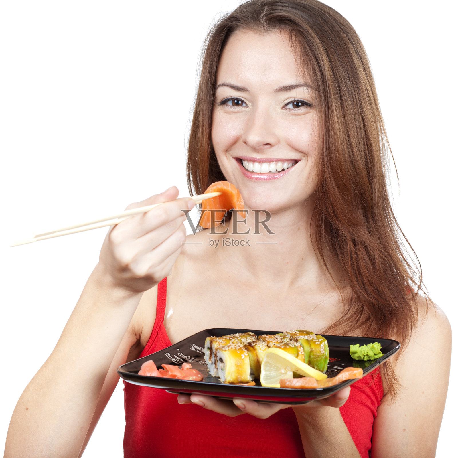 漂亮的黑发女人在吃寿司照片摄影图片