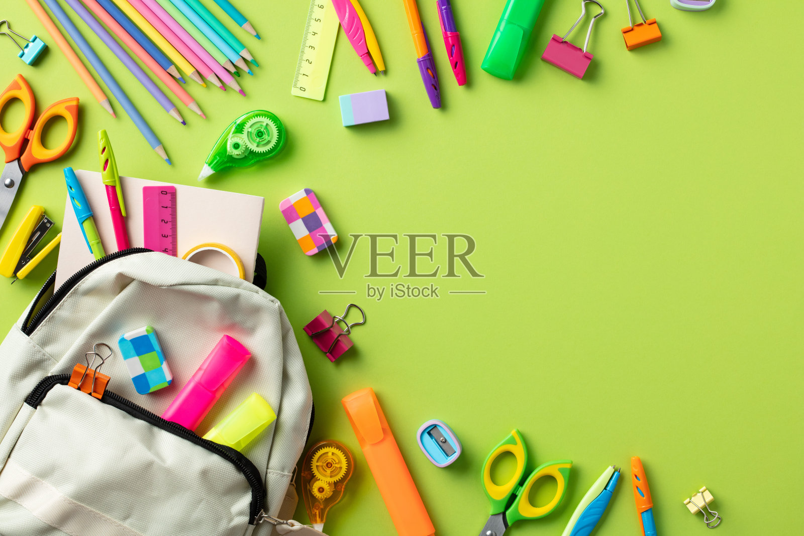 回到学校的概念。彩色背景书包与学校用品。照片摄影图片