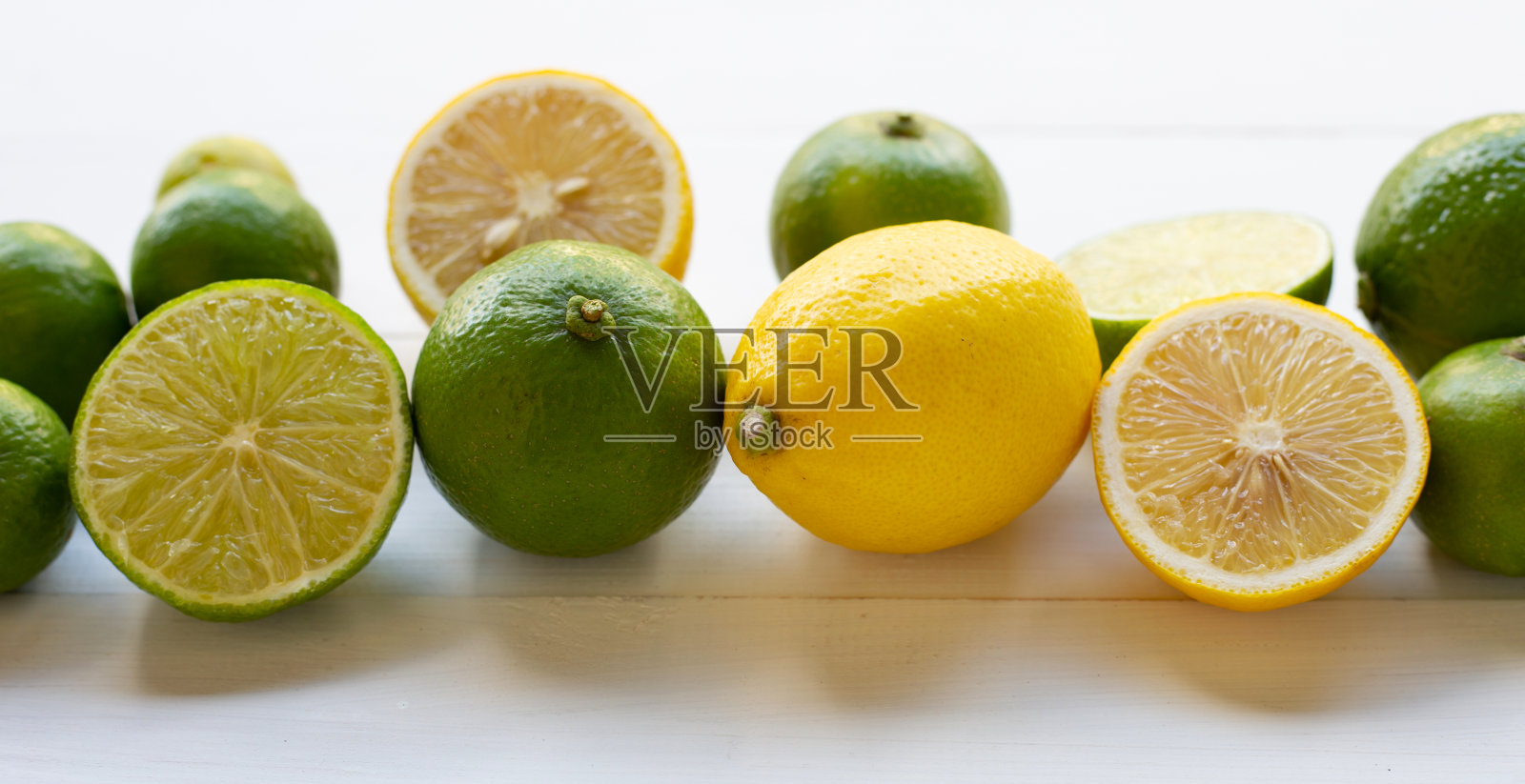 成熟的柠檬和酸橙上白。照片摄影图片