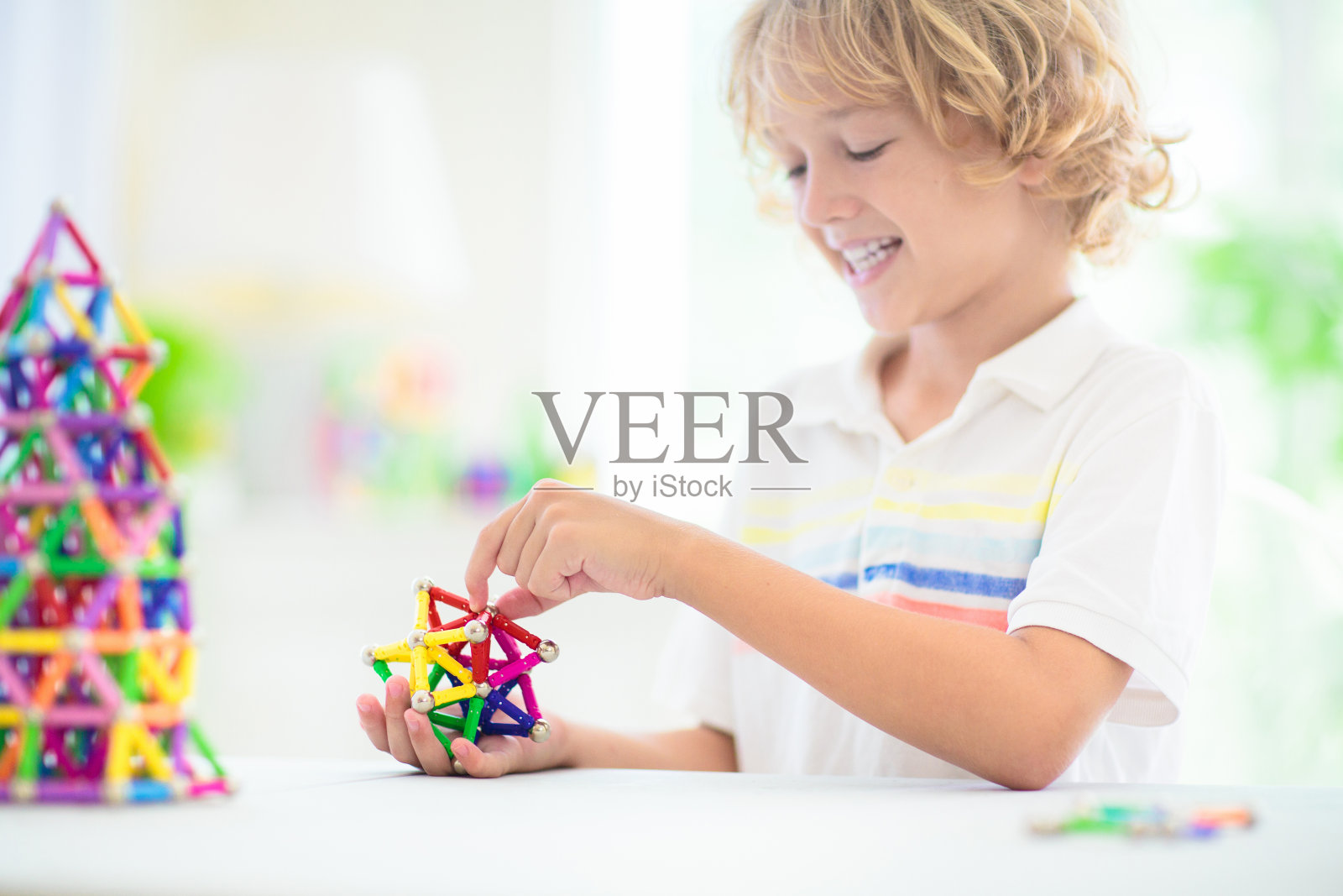 孩子在玩磁性积木。照片摄影图片