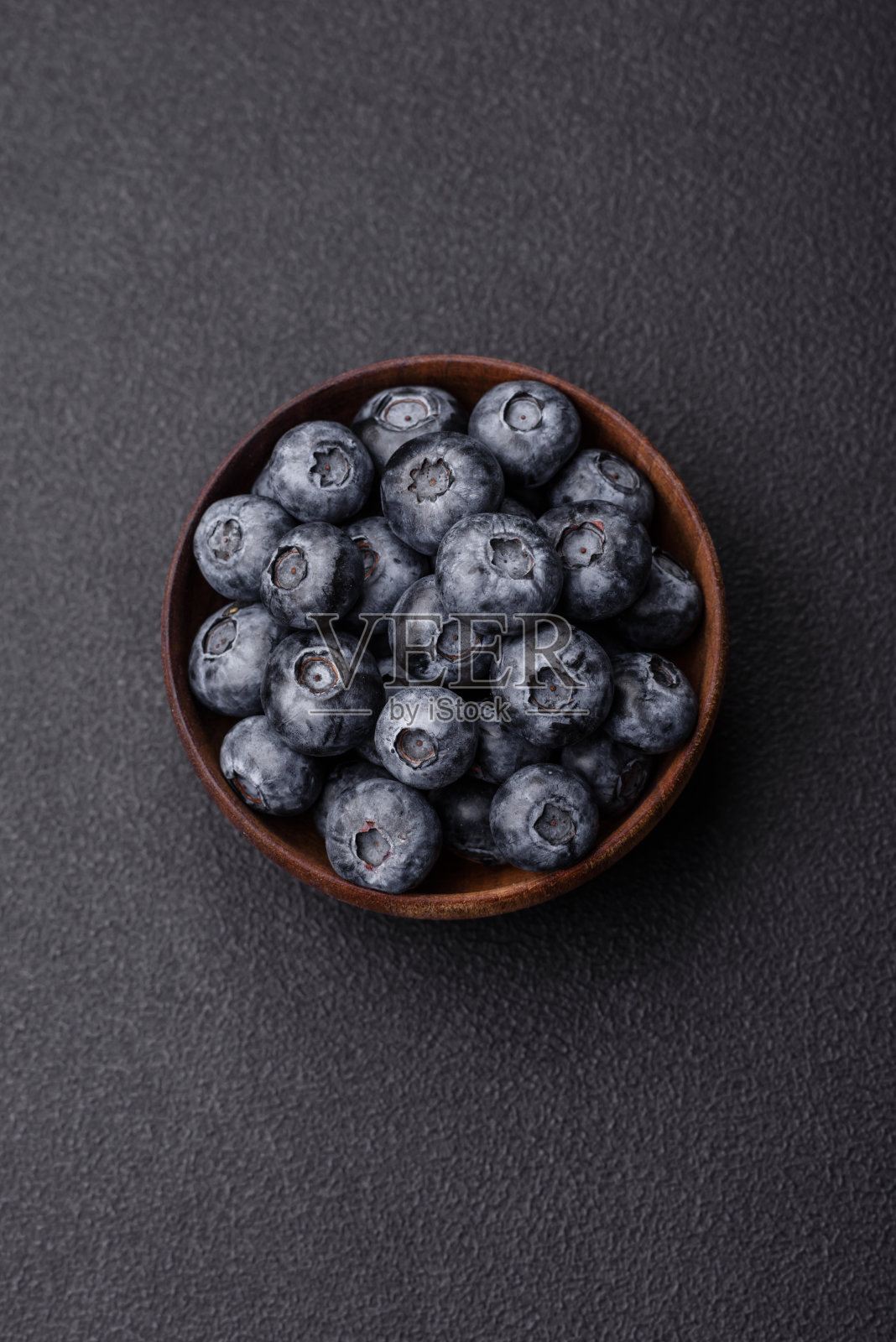 美味的新鲜甜蓝莓在一个陶瓷碗。素食照片摄影图片