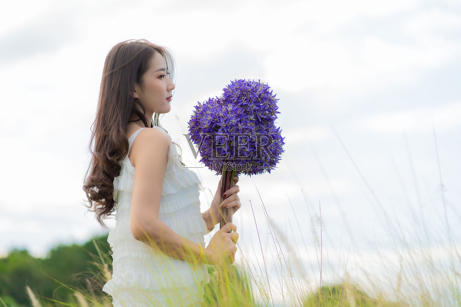 年轻的亚洲游客拿着紫色的花休息,享受着盛开的绣球花。生活方式女孩在泰国清迈的花园里采摘绣球花。照片摄影图片