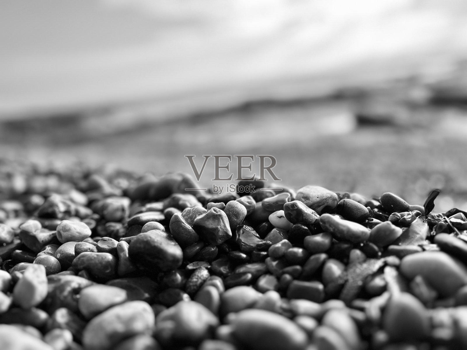 阳光照耀在惠特利湾海滩的鹅卵石上照片摄影图片