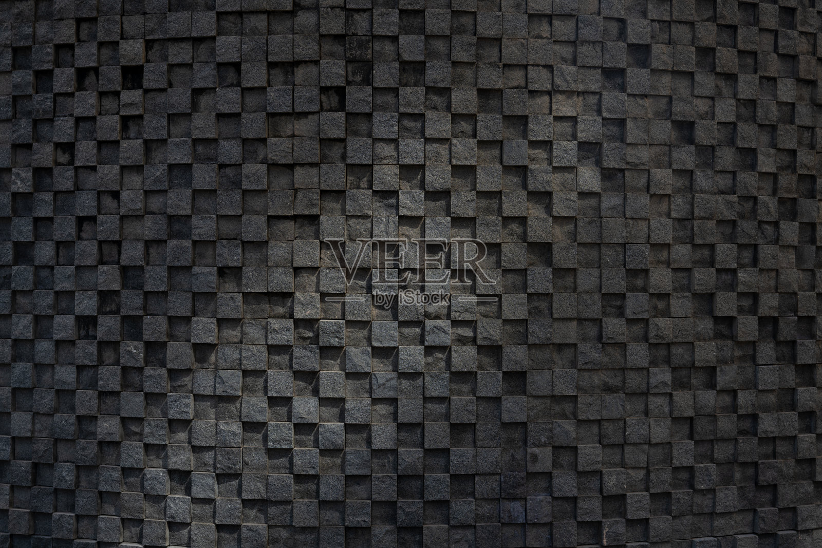 灯光照在石砌的艺术背景墙上照片摄影图片