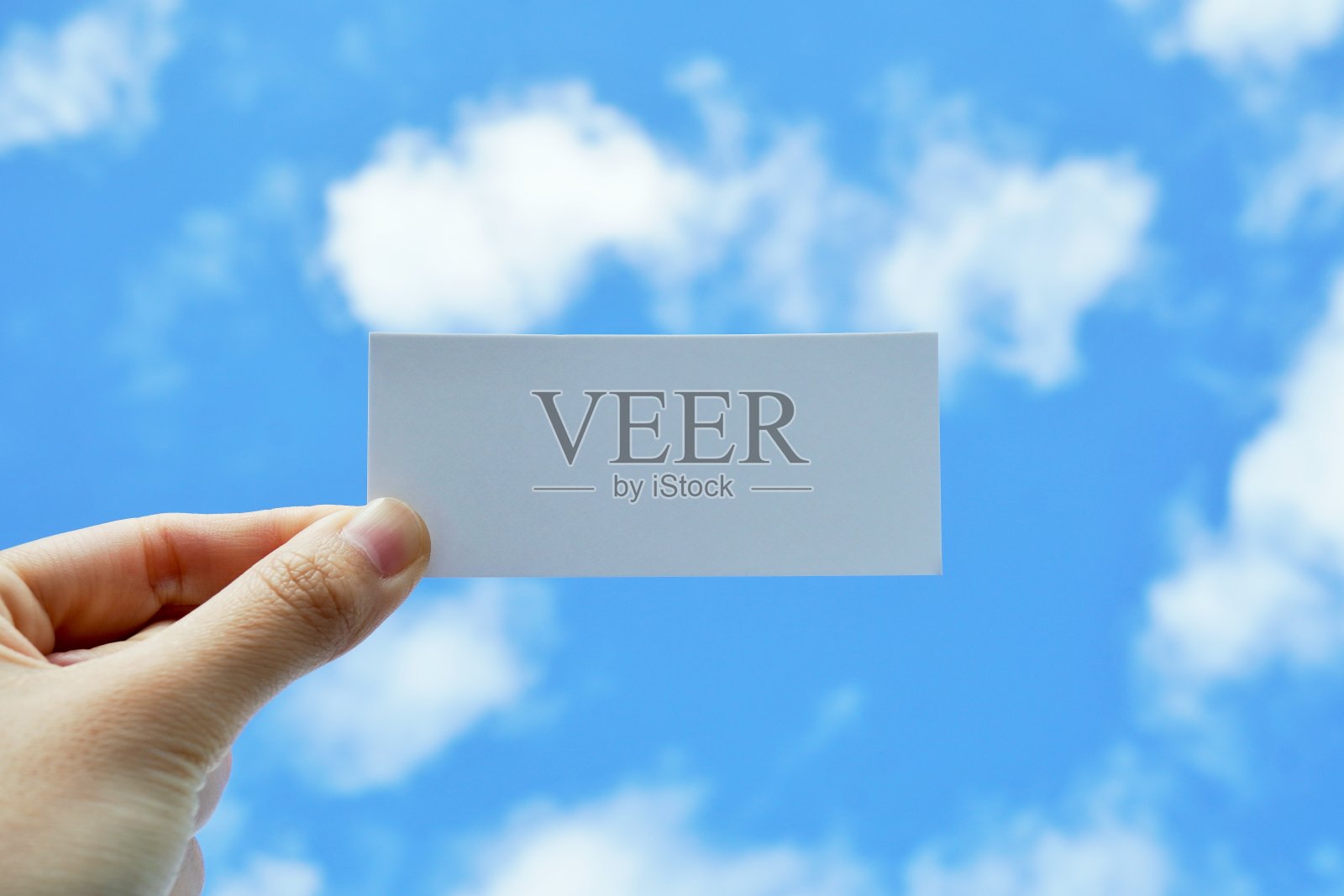 以蓝天白云为背景,一个女人举着的标题空间模型照片摄影图片