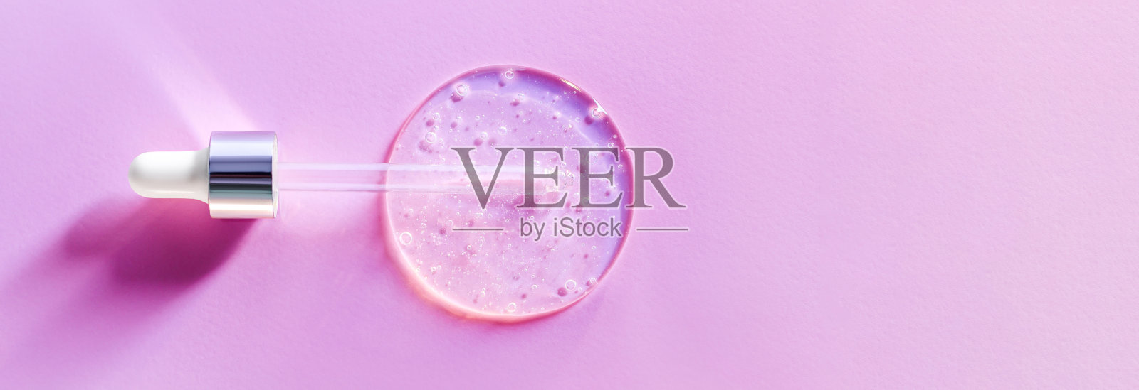 移液器滴在粉红色背景上的血清照片摄影图片